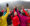 Dick Deming high-fiving others in a group at the base of a mountain