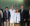 Photo of Kevin and Lorie Haarberg smiling, wearing pharmacy whites that were given to them as gifts from the College. Also photographed with them is President Dunn, Dean Dan Hansen, Provost Dennis Hedge, and other member of the college.