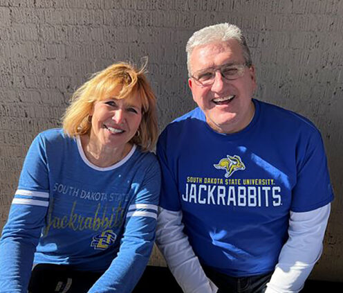 Elaine and Jerome Garry smiling together, wearing Jackrabbit gear