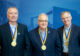 Tim Dwire, Steve Erpenbach, Keith Mahlum stand side by side, smiling, with their presidential medallions around their neck.