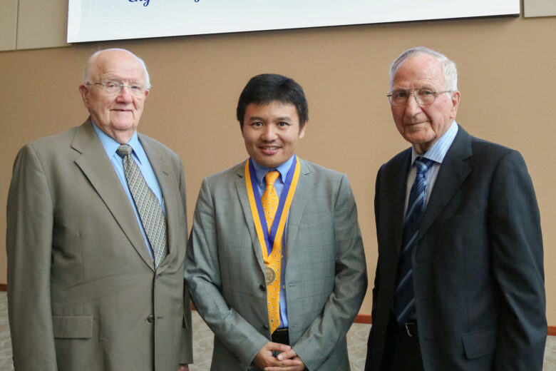 Duane Sander, Dr. Yucheng Liu, and Al Kurtenbach smile for a photo after the investiture ceremony.