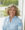 Professional headshot of Jill Hoflock, with blurred green background.