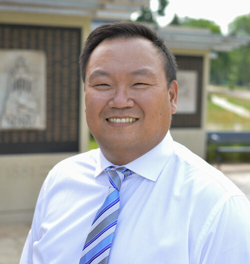 Professional headshot of Michael Livingston, with a blurred landscape background.