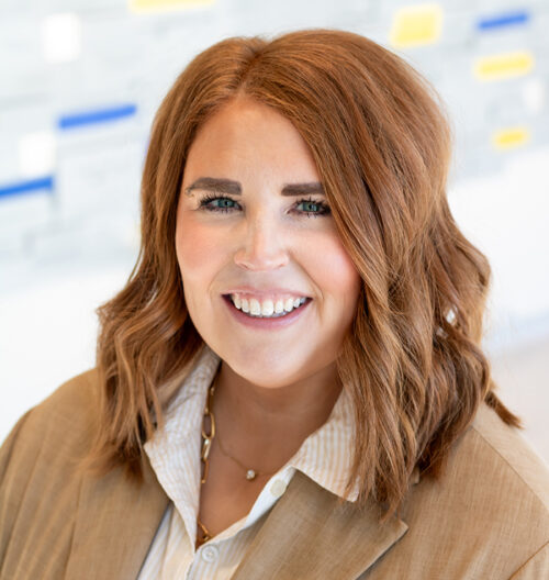 Professional headshot of Trish Noyes with a blurred background
