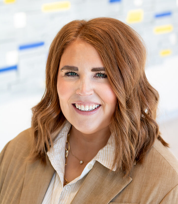 Professional headshot of Trish Noyes with a blurred background