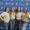 Abby smiles with three other female students infront of a SDSU themed step and repeat banner.