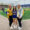 Cassie and two friends smiling at the corner of the Dana J. Dykhouse Football Stadium endzone.