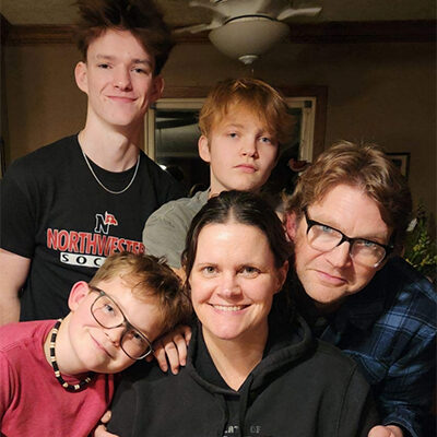 Photo of Jennifer Dolan smiling with her family