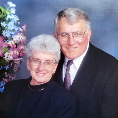 Frank and his late wife, Jean, smiling in a professional photo.