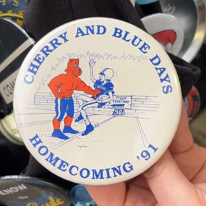 Button that reads "cherry and blue days - homecoming '91"