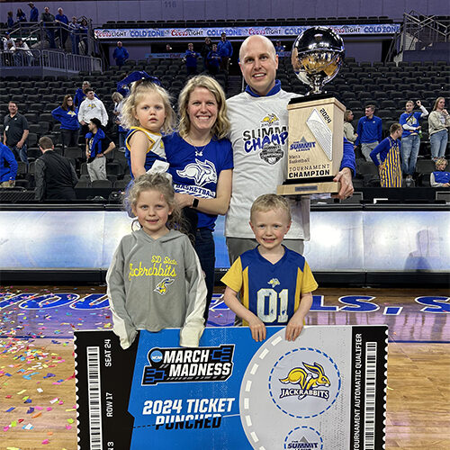 Erin Glidden and her husband Tyler with their three kids with at the Summit League Championship Game