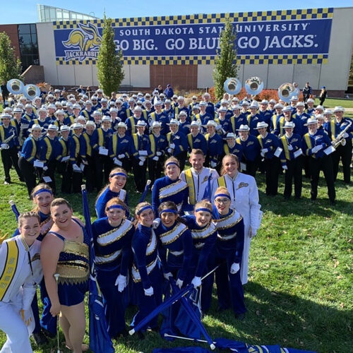 Aerial photo of the Pride smiling for a photo at College Game Day.