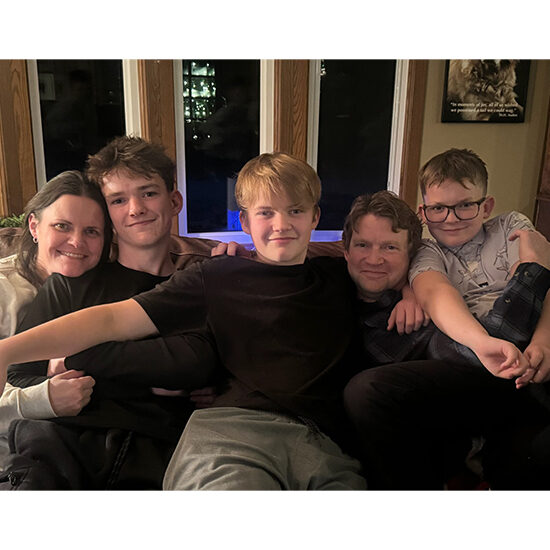 Photo of Jennifer Dolan smiling with her family.