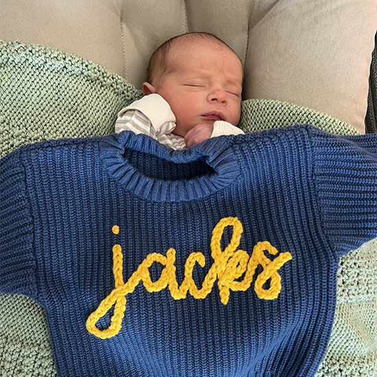 Tom Nieman's infant grandson, Jack, sleeps with a "Jacks" sweater laid overtop of him.