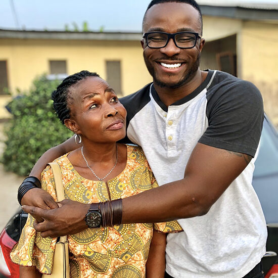 Sean Edeki embracing his mother, smiling ear to ear.