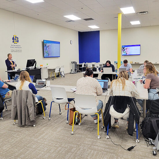 APhA training in a classroom at the Metro Center where students and pharmacists are participating in a certification course.