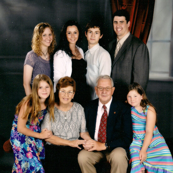 Lowell and Deanna Satterlee posing with their six grandchildren