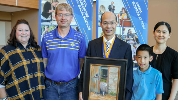 Everett and Bernie joined via Zoom and were represented by their grand-nephew, Eric Neuharth, and his wife, Tracee. Dr. Wang is holding an original painting that Bernie gifted him as a sign of confidence in what he brings to the position and for his dedication to SDSU.