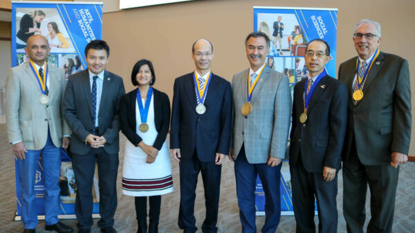 Photo of Dr. Zhiguang (Gerald) Wang standing with six others who hold endowed positions at SDSU.
