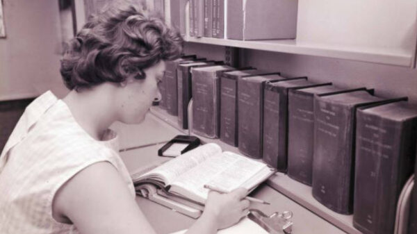 Young female student studying and reading a book.