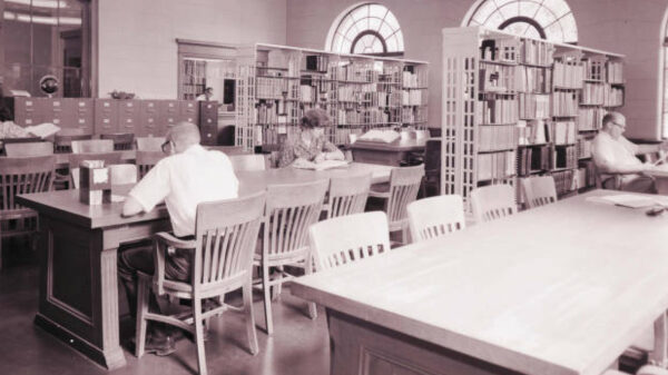 Students sitting at tables, reading and studying in the Lincoln Memorial Library.