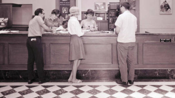 Group of people standing at the circulation desk at the Lincoln Memorial Library