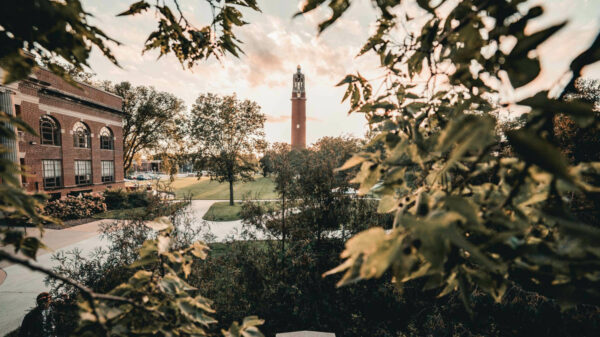 Photo of Campanile, with an amazing sky, and Lincoln Music Hall flanked to the left of the Campanile.