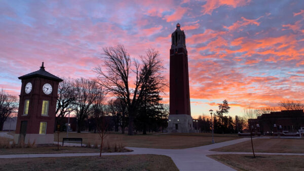 Early morning pink, purple and blue sunrise with a silhouette of the Campanile and bell tower in the foreground.