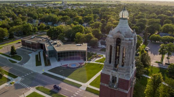 Aerial photograph showing the top of the Campanile, with the Lohr Building (SDSU Foundation and SDSU Alumni Association) in the background.