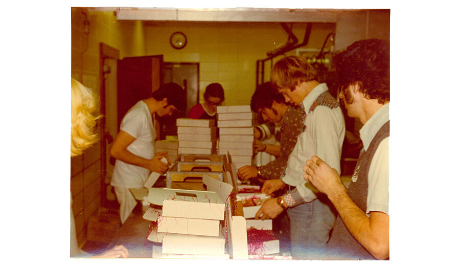 Vintage photo from the 1960's or 70's of SDSU students packing up cheese boxes.