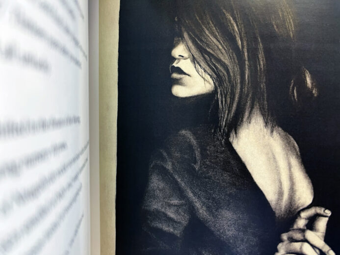 Photograph of the 2017 Oakwood Magazine, showcasing a beautiful black and white photograph of a charcoal drawing of a woman.