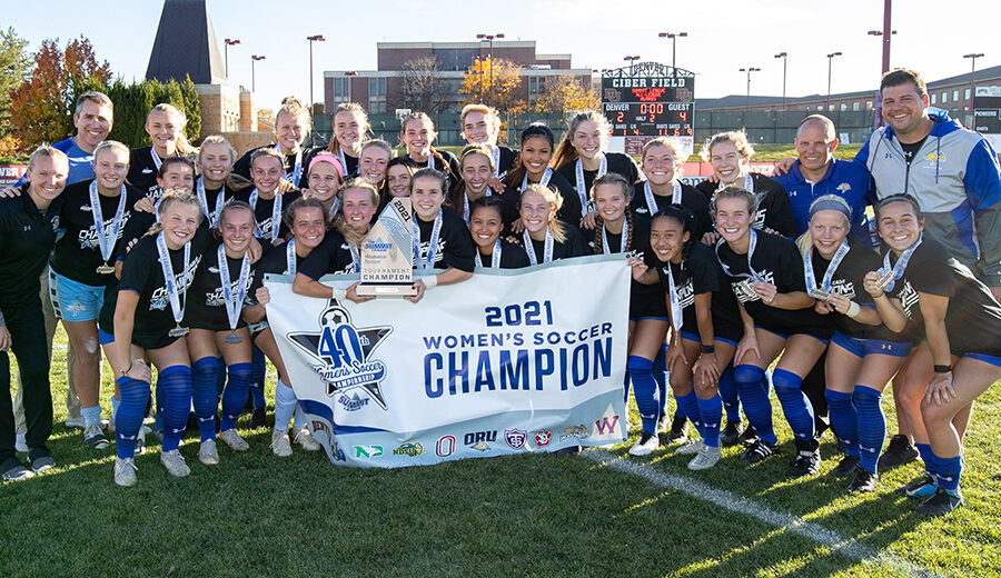 The SDSU soccer team poses with their trophy right after they won the 2021 Summit League Championship against Denver.