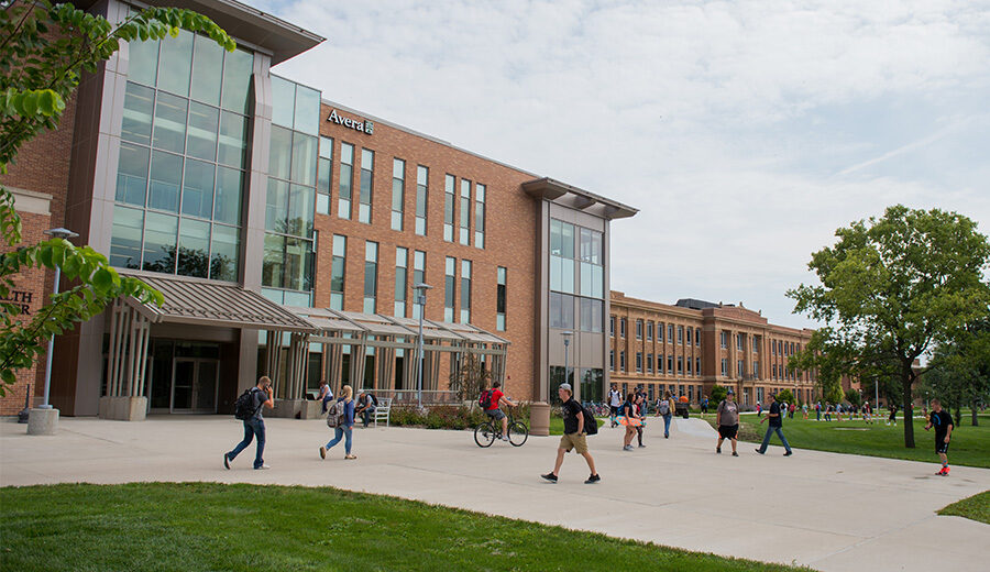 Avera Health and Science Center on the SDSU campus, shown with college students walking around outside of the building