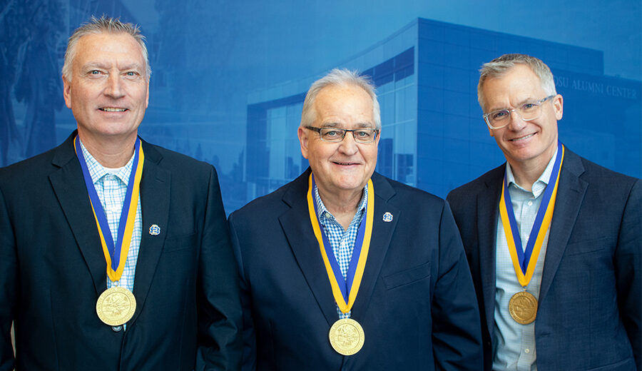 Tim Dwire, Steve Erpenbach, Keith Mahlum stand side by side, smiling, with their presidential medallions around their neck.