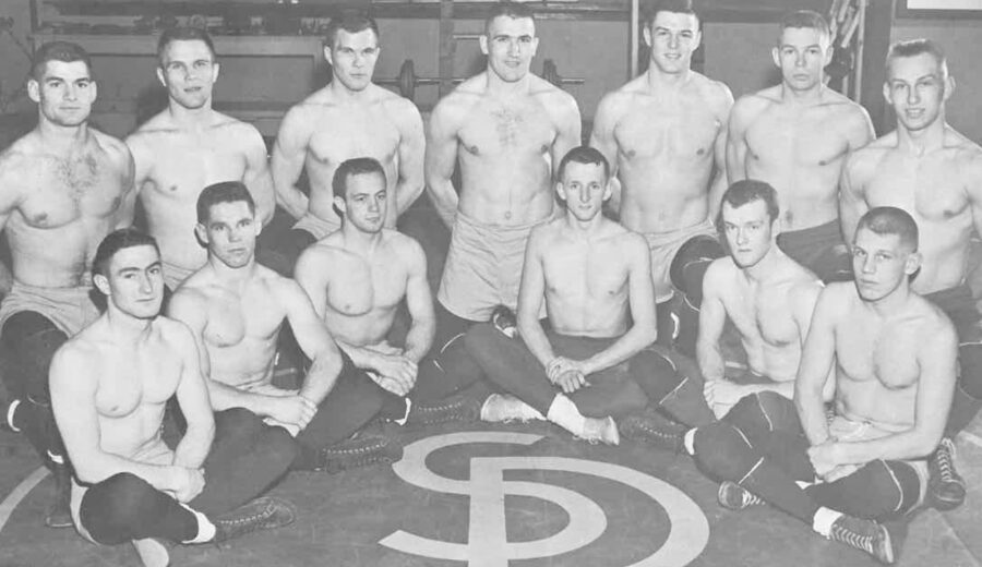 Kurtenbach, fourth from the left in the back row, poses with the wrestling team.